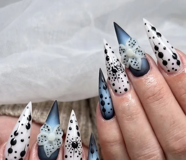 Long stiletto nails in black, white and smoky blue with 3D bows