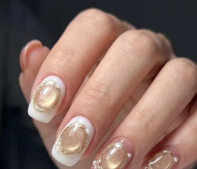 Pearl and gold framed nails on a milky white base