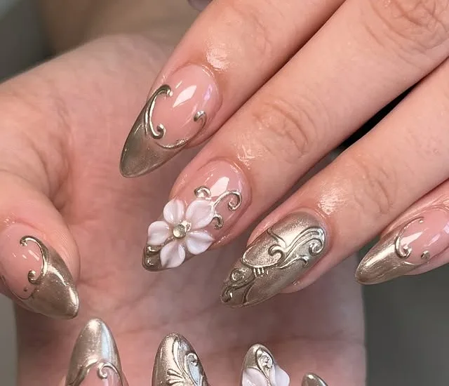 Chrome swirl almond nails with a 3D flower